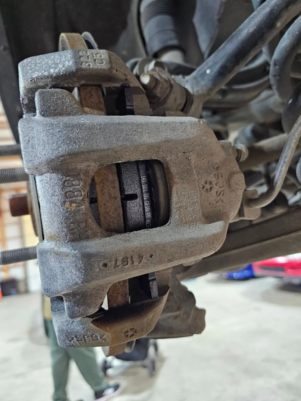 Worn brake caliper removed during a brake job