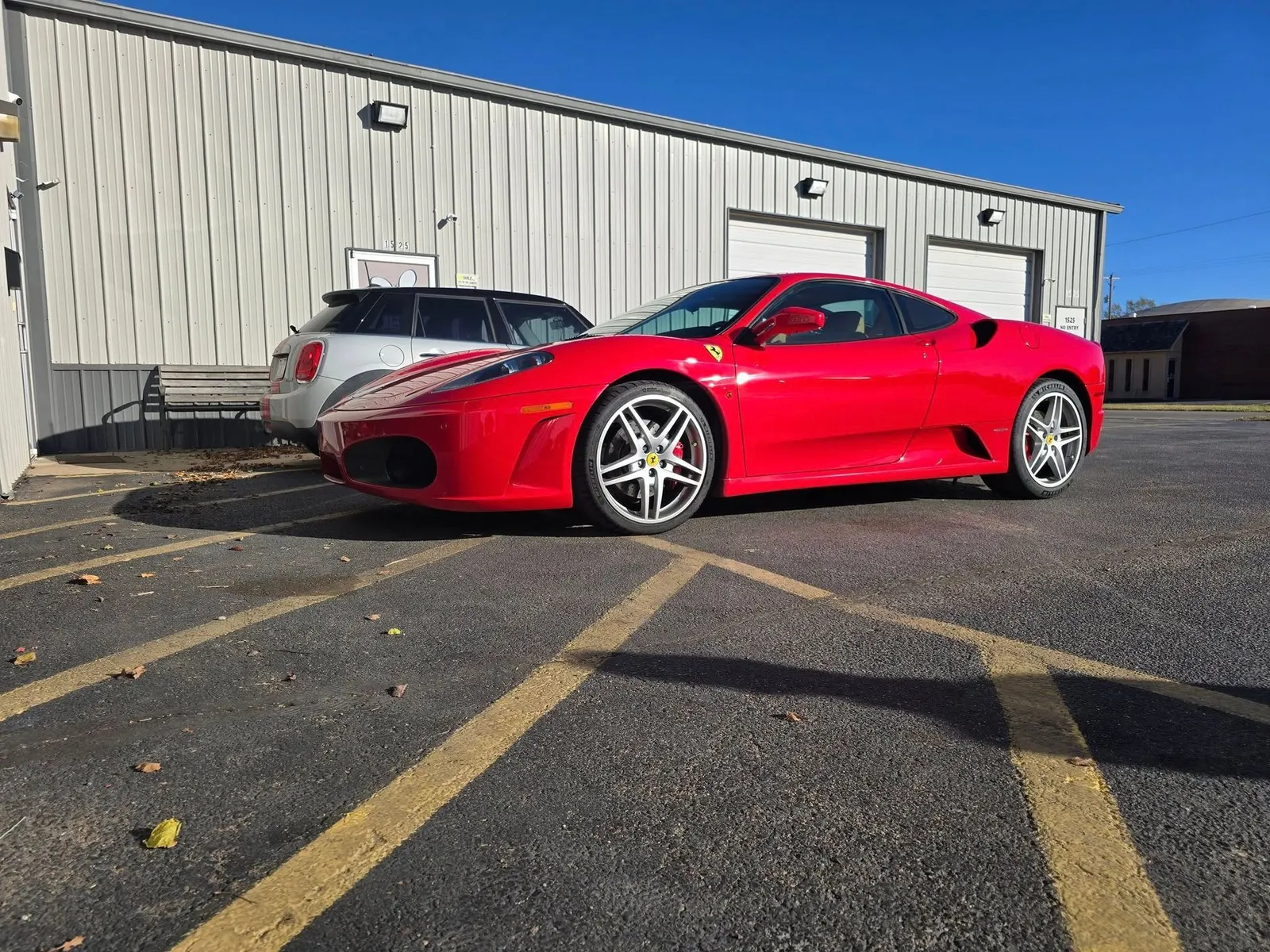 Red Ferrari F430 in the lot outside Juice Garage