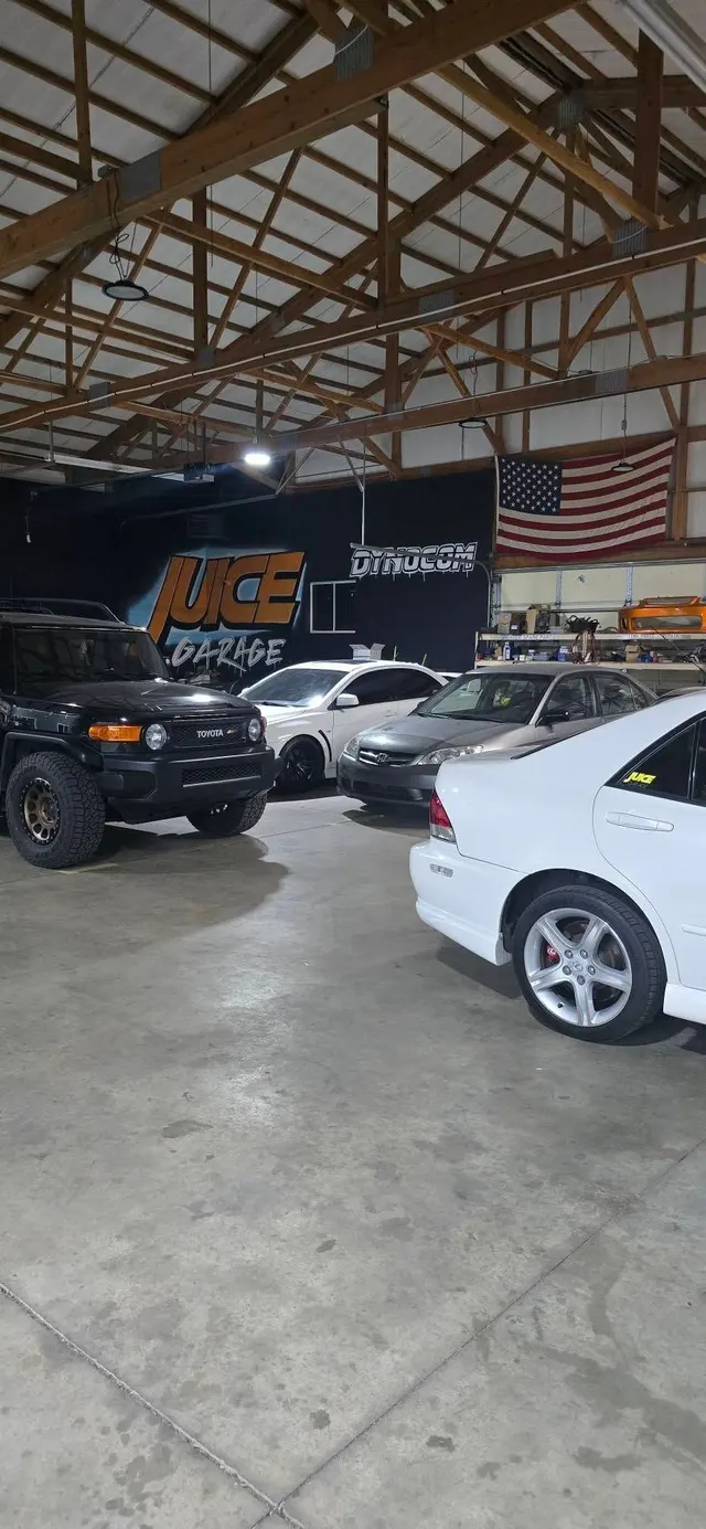 Cars on the shop floor inside Juice Garage in Wichita