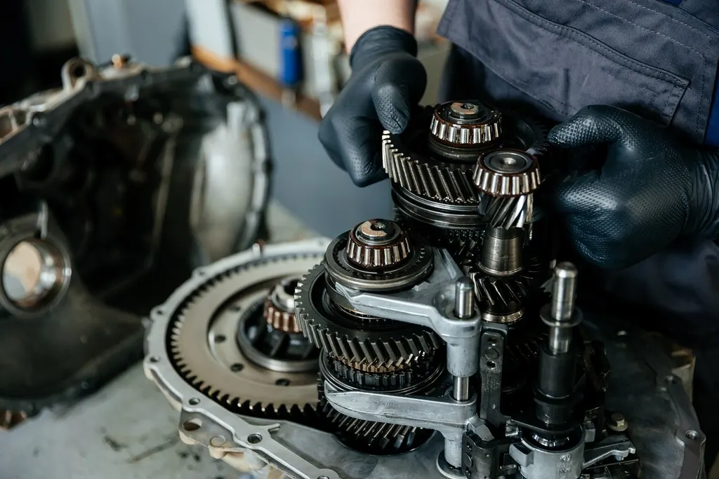 Technicians working on an opened transmission